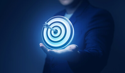 Businessman showing virtual target board on hand. Success concept, planning and setting goals objectives for business investment