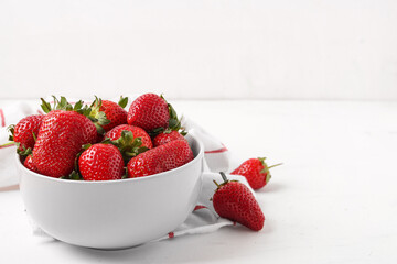 Bowl with sweet fresh strawberries on white background
