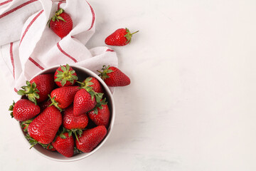 Bowl with sweet fresh strawberries on white background