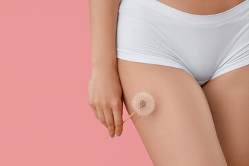 Beautiful young woman with white dandelion flower on pink background, closeup. Depilation concept