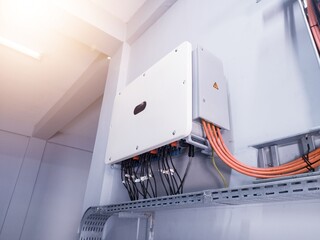 Instalation control of inverters solar panel on the wall. Technology of solar energy with shiny light. © Suranto