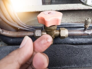 Checking for refrigerant gas leaks in outdoor HVAC systems. check oil leaks on cut off valve.