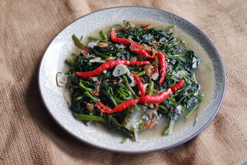 Stir fried Water Spinach or Kangkung with fried Anchovies. One of the famous Indonesian cuisine.
