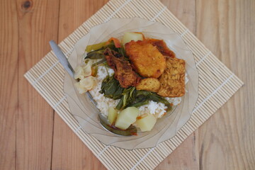 A plate of food on a table, a delicious meal consisting of various dishes arranged neatly on a plate.
