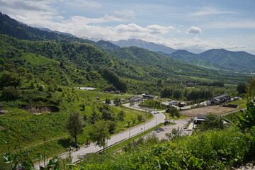 Naklejka premium Almaty, Kazakhstan - 05.22.2024 : An asphalt road in a mountainous area.