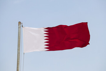 Waving flag of Qatar, in Doha