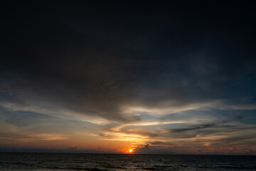 Summer windy day at the bay on beautiful sunset with sky full of small clouds