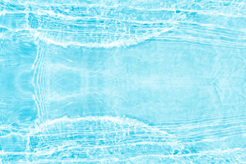Blue water with ripples on the surface. Defocus blurred transparent blue colored clear calm water surface texture with splashes and bubbles. Water waves with shining pattern texture background.