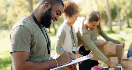 Happy people, volunteer and writing with clipboard for checklist on food, stock or supplies in...