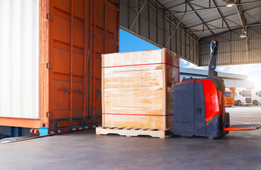 Electric Forklift Pallet Jack and Package Boxes Wrapped Plastic on Pallets. Loading Goods into...