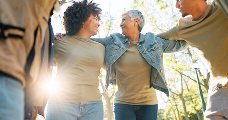 Hug, volunteer and group in park, sunshine and teamwork with collaboration, lens flare and support....