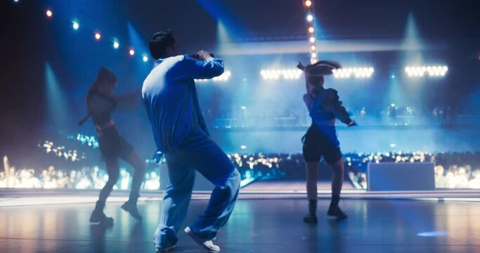 Male Pop Singer Lights Up the Night With a Creative Performance. Music Fans Enthusiastically Dance in the Fan Zone as Dazzling Choreography and Stunning Visuals Create a Magical Atmosphere on Stage
