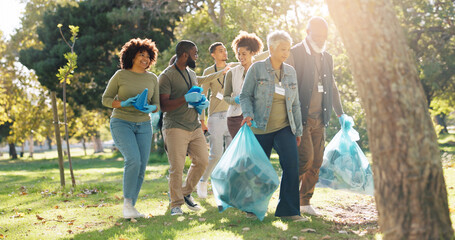 People, volunteer and smile for pick up dirt at park with plastic bag for cleaning, earth day and...