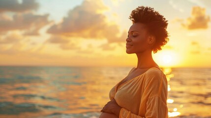 Fototapeta premium Portrait of a beautiful African American woman against the background of the sea at sunset