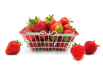 Shopping supermarket basket with fresh organic ripe strawberries whole and heap isolated on a white...