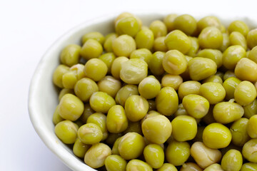 Canned green peas on white background.