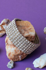 A gleaming metal bracelet adorned with radiant white stones, showcasing elegance and craftsmanship.