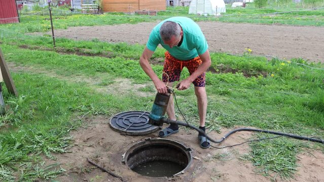 Septic tank maintenance, pumping sewage with wastewater pump.