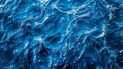 Blue water surface with bright sun light reflections background.