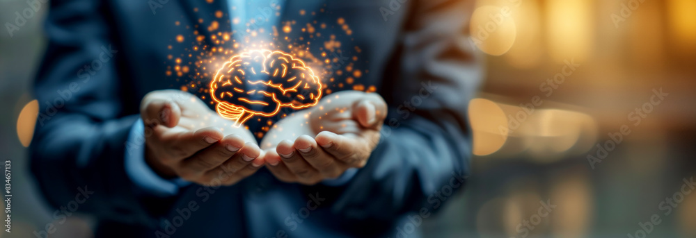 Poster a person in a suit holding an illuminated brain, symbolizing ideas and innovation, on a blurred back