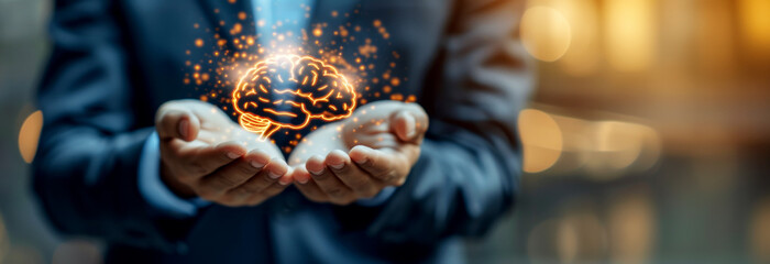 A person in a suit holding an illuminated brain, symbolizing ideas and innovation, on a blurred background. Generative AI