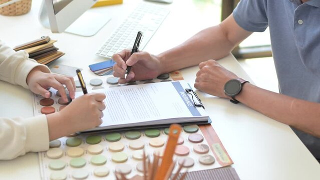 Unrecognizable male contractor pointing at contract document to client put a signature