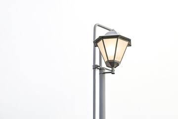 Street lamp against white sky