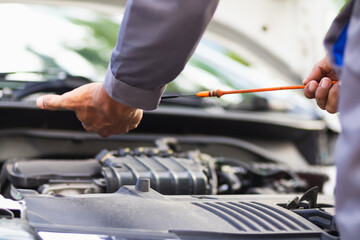 car service center mechanics are checking condition car and engine make sure they are ready use and in perfect condition according center warranty. periodic vehicle inspections for safety in driving.