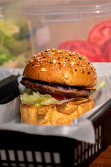 A mouthwatering hamburger beautifully presented, showcasing its juicy patty, fresh toppings, and perfectly toasted bun.