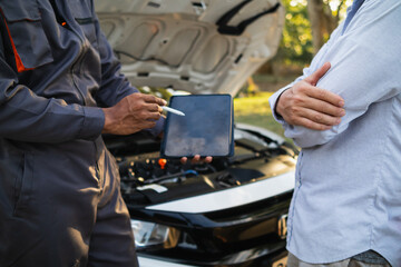Technicians from service center inspect and assist customers cars that are having problems while...