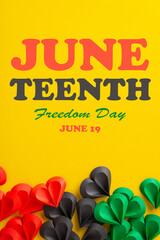 A festive vertical display of red and green paper hearts scattered on a vibrant yellow background celebrating Juneteenth, symbolizing unity and freedom