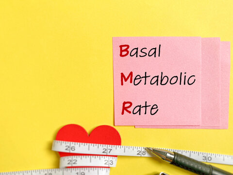 Basal Metabolic Rate, BMR written on adhesive notepaper background. Stock photo.