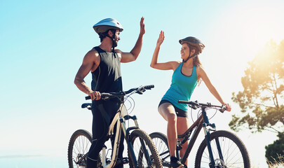 Man, woman or together on bicycle with high five in countryside for exercise, celebrate for workout...
