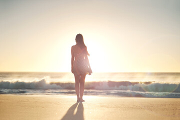 Woman, back and sunset with travel to beach with reflection, relax and vacation by waves. Girl,...