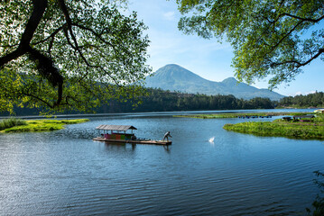 Fishermen in Telaga Menjer cast their nets in the bright morning sun