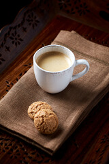Cup of coffee on wooden background. Close up.