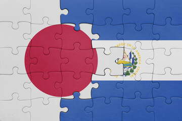 puzzle with the colourful national flag of el salvador and flag of japan.