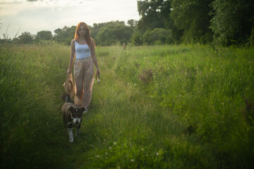 Young woman walking the dogs in nature