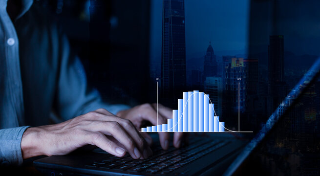 Businessman work with laptop and analyzing distribution data with histogram graph statistical process control and development process at workplace, quality control improvement concept