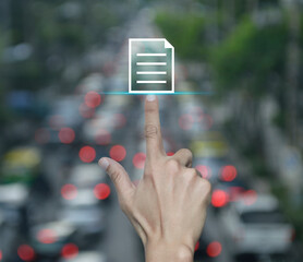 Hand pressing document flat icon over blur of rush hour with cars and road in city, Technology...