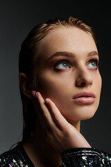 Fototapeta premium A young woman with striking eyes poses elegantly.