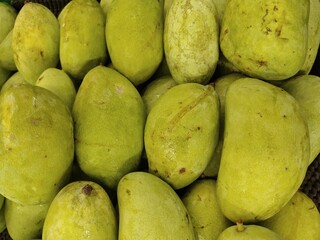 fresh green mango. healthy fruit background, sign and symbol.