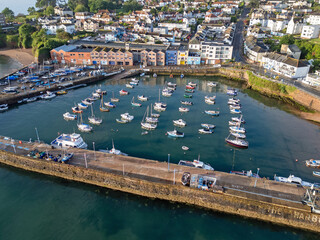 Naklejka premium An aerial image of Paignton harbour on a clear sunny morning with blue skies and a calm sea