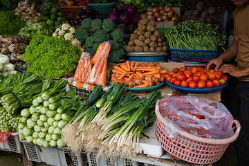 Beautifully arranged fresh vegetables at a traditional market, for sale.