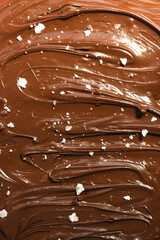 Molten chocolate, with salt flakes..Chocolate background.
