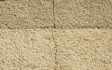 Plastered exterior wall of a house with a crack