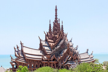 Intricate Wooden Temple Against Blue Sky and Sea, Sanctuary Of Truth, Pattaya, Thailand
