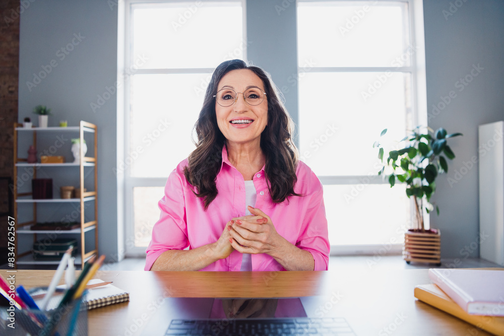 Poster photo of cheerful charming successful woman sitting speaking vacancy video call workspace indoors