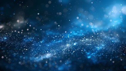 Fototapeta premium Abstract blue glowing particles background with a bokeh effect 