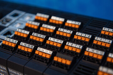 Analog and digital inputs of the Programmable Logic Controller PLC. Selective focus.